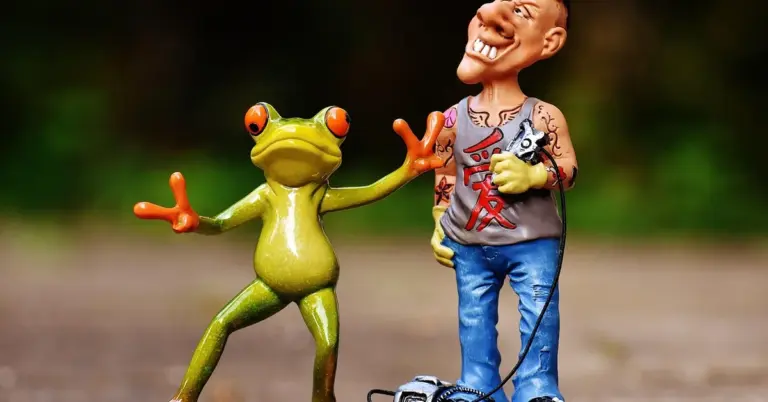 Cartoon frog figurine extending a hand toward a tattooed man figurine outdoors, illustrating transformation.