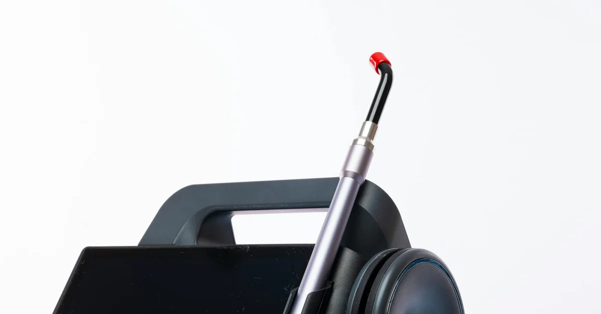 Close-up of a pico laser handpiece with a red-tipped nozzle against a white background.