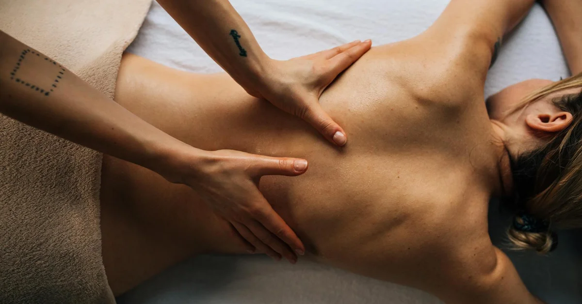 Therapist performing a back massage on a client to illustrate the standard treatment timeline and frequency.