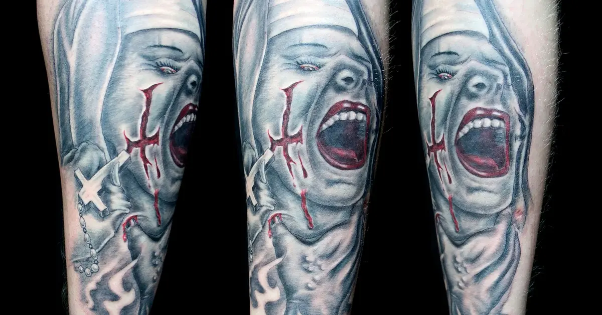 Blue-gray tattoo on an arm across three panels, featuring a screaming face with red stitched lines and a white cross symbol on the left.